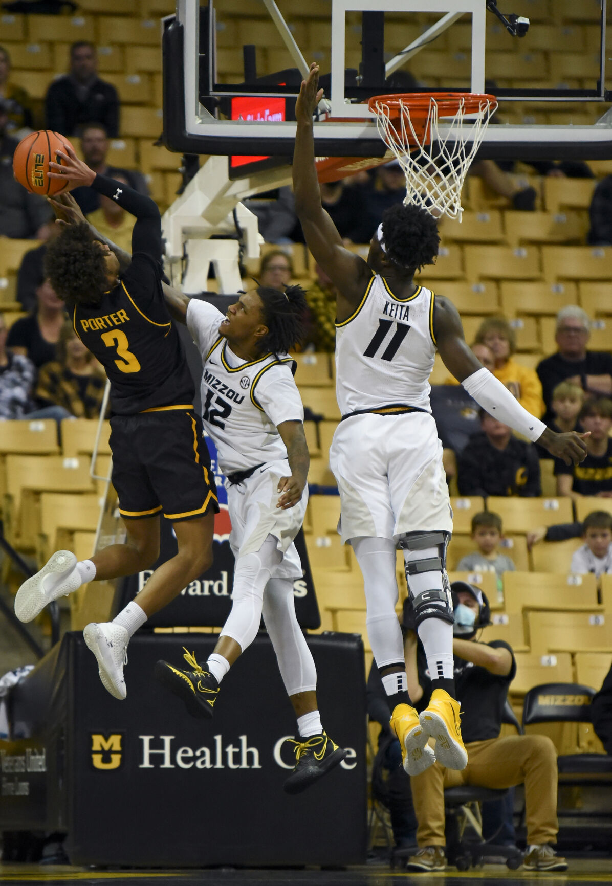 Missouri's DaJuan Gordon, center, and freshman forward Yaya Keita attempt to block Wichita State's Craig Porter Jr.’s jump shot